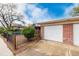 A brick house with a large two-door garage and a gated yard with mature shrubbery at 6005 W 39Th Ave # 6005, Wheat Ridge, CO 80033