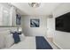 Comfortable bedroom featuring neutral paint, modern accents, and a wall mounted TV at 6005 W 39Th Ave # 6005, Wheat Ridge, CO 80033