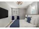 A comfortable bedroom featuring neutral paint, modern lighting, and generous windows at 6005 W 39Th Ave # 6005, Wheat Ridge, CO 80033