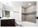 Bathroom featuring tile-surround shower and a dark vanity at 1898 S Bannock St # 505, Denver, CO 80223