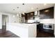 Modern kitchen featuring an island with seating, stainless steel appliances, and sleek cabinetry at 1898 S Bannock St # 505, Denver, CO 80223