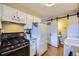 Charming kitchen features white cabinets and modern appliances at 8051 Wolff St # I, Westminster, CO 80031
