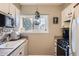 Functional kitchen features a window above the sink and black appliances at 8051 Wolff St # I, Westminster, CO 80031