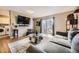 Living room featuring wood floors, a TV, a sliding glass door, and contemporary decor at 8051 Wolff St # I, Westminster, CO 80031