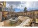 Back patio with covered seating, a grill, and outdoor air conditioning unit at 8051 Wolff St # I, Westminster, CO 80031
