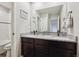 Bathroom features a double sink vanity with a granite countertop and dark brown cabinetry at 8852 Ventura St, Commerce City, CO 80022
