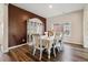 Traditional dining room showcasing wood floors, an accent wall, and a decorative china cabinet at 8852 Ventura St, Commerce City, CO 80022