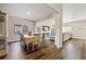 Open concept dining room and living room filled with natural light and featuring luxury vinyl plank flooring at 8852 Ventura St, Commerce City, CO 80022