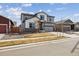 Charming two-story home featuring gray and white siding, a well-kept lawn, and an attached two-car garage at 8852 Ventura St, Commerce City, CO 80022