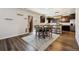 Eat in kitchen featuring dark cabinetry, stainless steel appliances, and luxury vinyl plank flooring at 8852 Ventura St, Commerce City, CO 80022