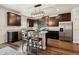 Kitchen featuring dark cabinetry, stainless steel appliances, granite countertops, and luxury vinyl plank flooring at 8852 Ventura St, Commerce City, CO 80022