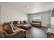 Relaxing living room showcasing comfortable seating and wood flooring at 8852 Ventura St, Commerce City, CO 80022