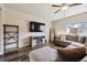 Cozy living room featuring luxury vinyl plank flooring, a large window, and a decorative shelving unit at 8852 Ventura St, Commerce City, CO 80022