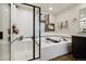 Luxurious bathroom features a soaking tub, a separate shower, and modern tiled floors at 8852 Ventura St, Commerce City, CO 80022