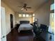 Spacious main bedroom with ceiling fan, three windows, and dark wood floors at 20678 E Lake Cir, Centennial, CO 80016