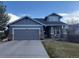 Charming two-story home with gray siding, brick accents, a covered porch, and a well-manicured front yard at 20678 E Lake Cir, Centennial, CO 80016