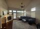 Bright living room with vaulted ceilings, fireplace, large windows, and plush sofa at 20678 E Lake Cir, Centennial, CO 80016