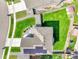 Aerial view of home with solar panels, a manicured lawn, and a fenced backyard at 562 Gallo St, Brighton, CO 80603