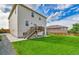 Back of house showing manicured lawn, siding, deck and walkout basement at 562 Gallo St, Brighton, CO 80603