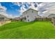 Expansive backyard with lush lawn, fenced perimeter, walkout basement, and deck at 562 Gallo St, Brighton, CO 80603