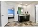 En-suite bathroom featuring a double sink vanity and tiled flooring adjacent to the main bedroom at 562 Gallo St, Brighton, CO 80603