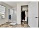 Bright bathroom featuring a walk-in shower with glass doors and a closet at 562 Gallo St, Brighton, CO 80603