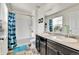 Bathroom with a tub and shower combo, blue shower curtain and double sink at 562 Gallo St, Brighton, CO 80603