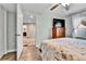 Bedroom featuring a ceiling fan, wood floors, and a view of the bathroom at 562 Gallo St, Brighton, CO 80603