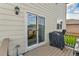 View of the deck with a sliding glass door, a grill, and outdoor lighting at 562 Gallo St, Brighton, CO 80603