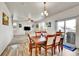 Dining area with wood table and chairs adjacent to a bright, open living space at 562 Gallo St, Brighton, CO 80603