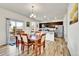 Open-concept dining area with modern lighting adjacent to a kitchen with stainless steel appliances at 562 Gallo St, Brighton, CO 80603