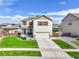 Charming two-story home with a well-manicured lawn and a welcoming two-car garage at 562 Gallo St, Brighton, CO 80603