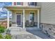 Inviting front porch with cozy seating and fresh landscaping at 562 Gallo St, Brighton, CO 80603