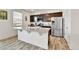 Modern kitchen featuring an island, stainless steel appliances, and ample counter space at 562 Gallo St, Brighton, CO 80603