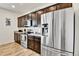 Well-equipped kitchen featuring stainless steel appliances, wooden floors, and sleek countertops at 562 Gallo St, Brighton, CO 80603