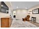 Cozy living room features a chair, TV, and doorway to the bathroom at 562 Gallo St, Brighton, CO 80603