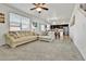Spacious living room with plush carpeting seamlessly flows into dining and kitchen areas at 562 Gallo St, Brighton, CO 80603