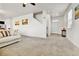 Bright living room with neutral walls, plush carpet, and open entryway at 562 Gallo St, Brighton, CO 80603