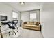 Office area with a desk, chair, sofa, and two windows for ample light at 562 Gallo St, Brighton, CO 80603