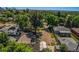 An aerial view of the neighborhood with rooftops, and greenery with a city skyline in the distance at 449 Lowell Blvd, Denver, CO 80204