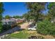Backyard with mature tree, parking area, and fenced neighboring home at 449 Lowell Blvd, Denver, CO 80204