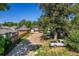 Large backyard with mature trees, parking, and neighboring houses visible at 449 Lowell Blvd, Denver, CO 80204