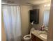 Bathroom featuring a shower with a curtain, a cabinet and a granite countertop sink at 449 Lowell Blvd, Denver, CO 80204