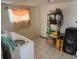Functional laundry room with a washing machine, a window and metal shelving for storage at 449 Lowell Blvd, Denver, CO 80204