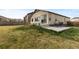 Spacious backyard featuring a concrete patio, small porch, well-maintained lawn, and privacy fence at 17960 Weymouth Ave, Parker, CO 80134