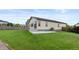 Spacious backyard with a large lawn, stone patio, and fenced perimeter at 17960 Weymouth Ave, Parker, CO 80134