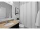 Bright bathroom features a granite vanity and shower with curtain at 17960 Weymouth Ave, Parker, CO 80134