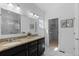 Bright bathroom features a double vanity with granite counters, stylish tile floors, and a walk-in closet at 17960 Weymouth Ave, Parker, CO 80134