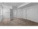 Spacious bedroom boasts neutral carpet, an open doorway, and a closet with sliding doors at 17960 Weymouth Ave, Parker, CO 80134