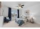 Cozy bedroom with plush carpeting, a ceiling fan, and natural light from large window at 17960 Weymouth Ave, Parker, CO 80134